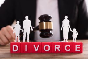 Judge's gavel behind blocks spelling out divorce