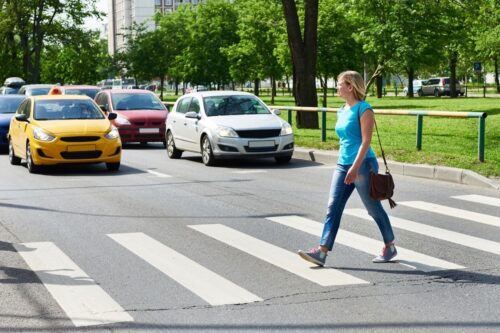 A woman crossing a pedestrian lane in Arizona.