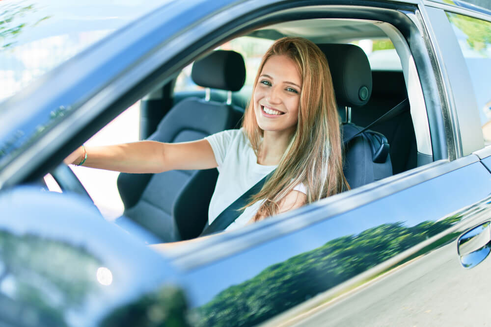 Girl teen driving happily.