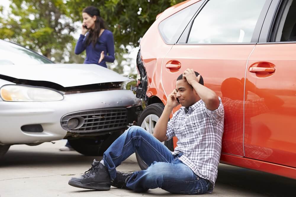 Driver calling insurance company to report accident.