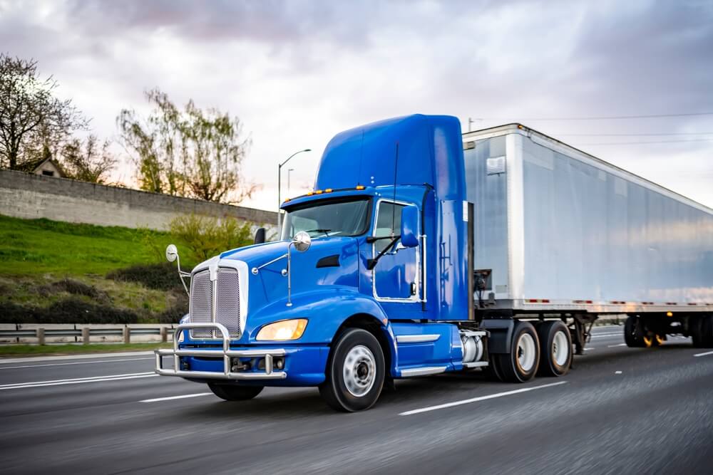 Blue truck passing the interstate highway.