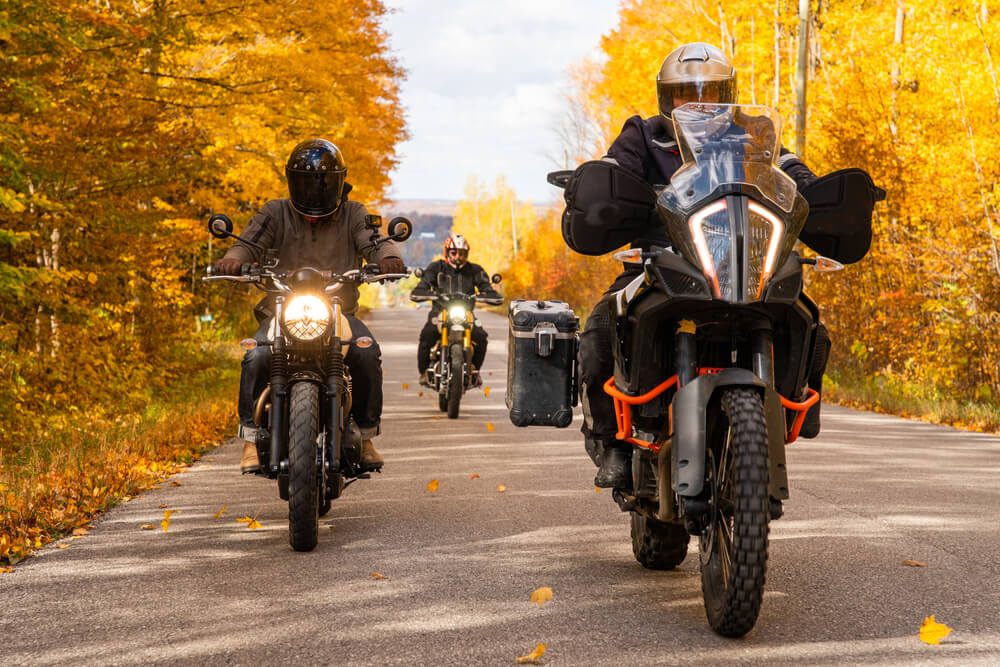 Group of friends riding motorcycles in the fall.