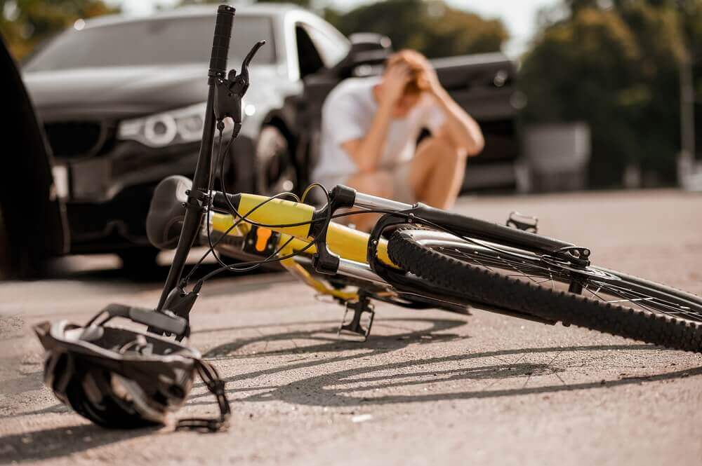 Cyclist got hit by a car causing injury.