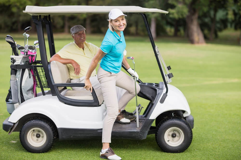 Couple riding the golf cart.